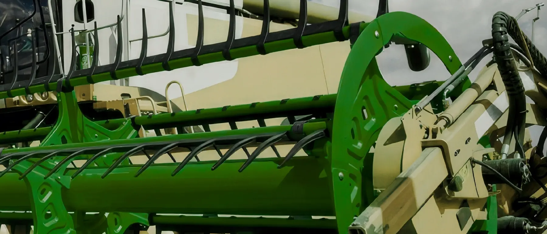 Combine harvester header and reel working in a field