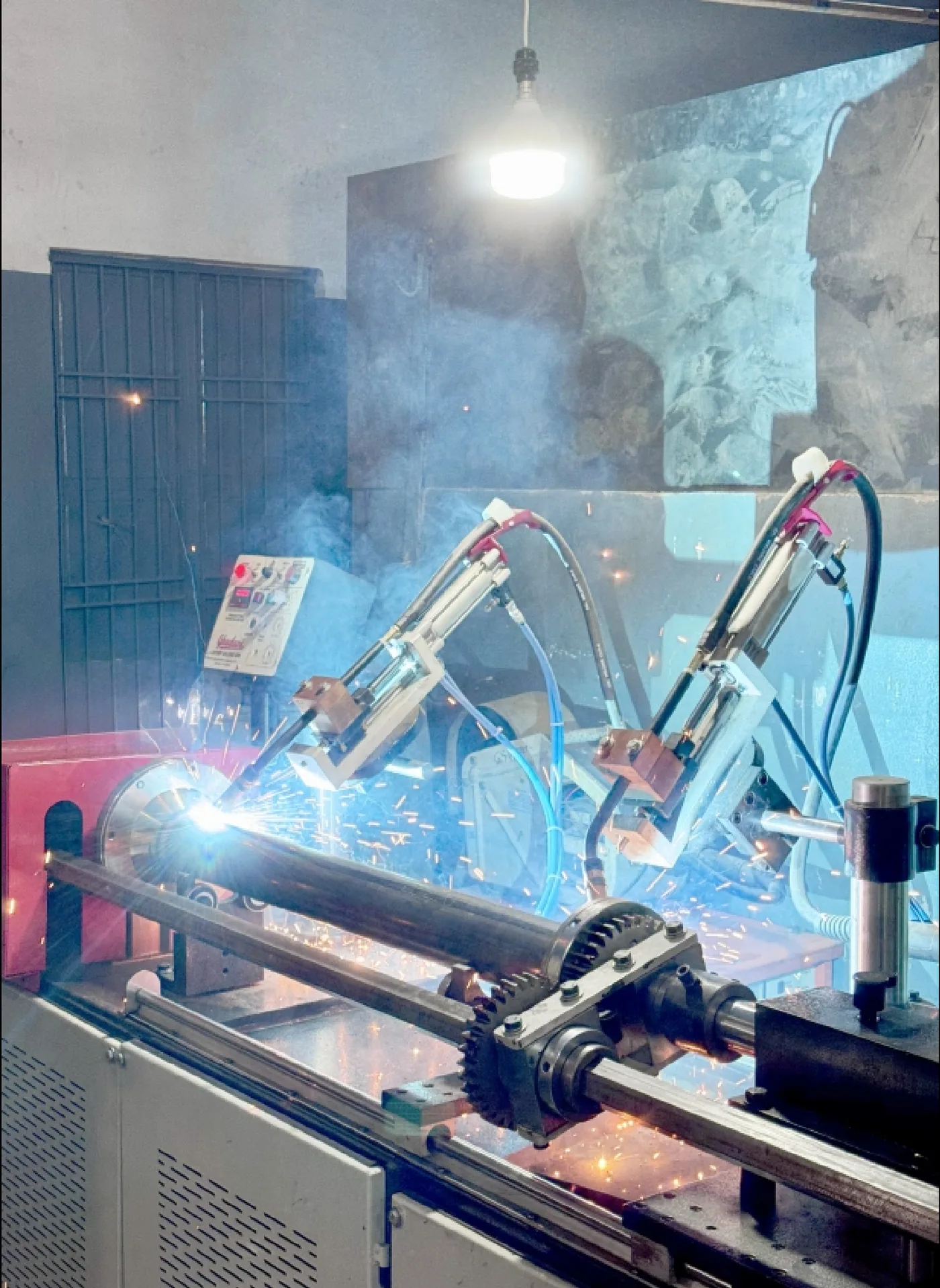 Robotic welding cell joining a gearbox drive pipe assembly